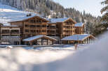 Nestled in a snow-covered forest, this stunning chalet-style hotel offers breathtaking views and luxurious accommodations.