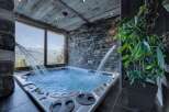 Luxury chalet with stunning mountain views and a private hot tub.