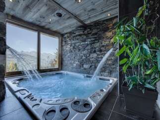 Luxury chalet with stunning mountain views and a private hot tub.