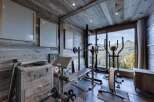 Luxury chalet gym with stunning mountain views.