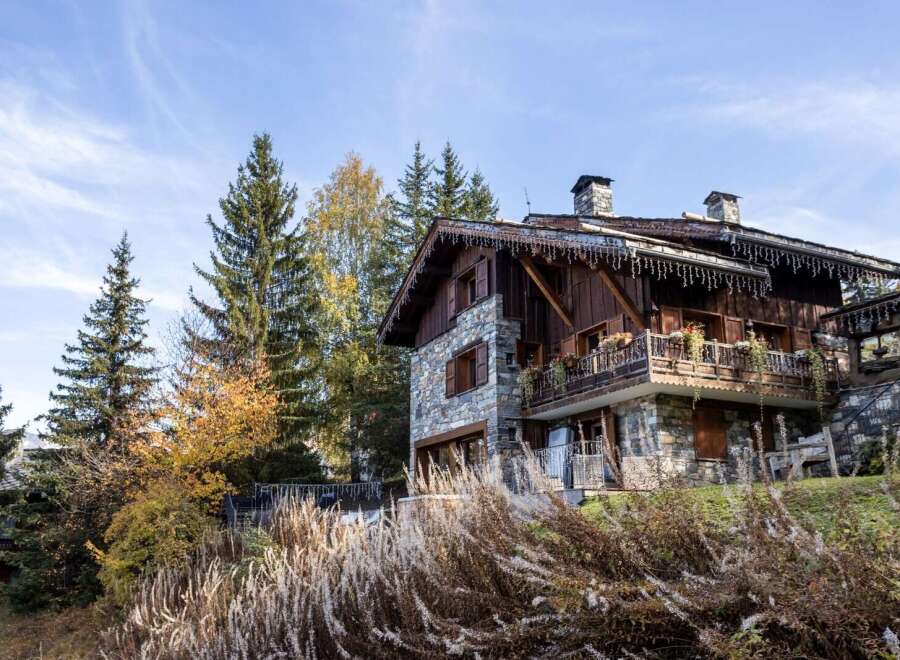 Charming stone chalet nestled in the French Alps, boasting stunning mountain views and a spacious balcony.