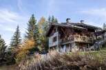 Charming stone chalet nestled in the French Alps, boasting stunning mountain views and a spacious balcony.