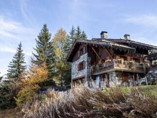 Charming stone chalet nestled in the French Alps, boasting stunning mountain views and a spacious balcony.