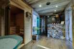 Indulge in ultimate relaxation in this luxurious spa featuring a traditional wooden sauna and a modern steam shower.