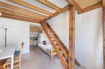 Discover this charming property featuring a unique loft design with wooden beams and a cozy sleeping area.