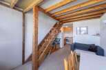 Discover this charming property featuring a unique loft design with exposed wooden beams and a staircase.
