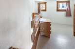 Discover a charming property featuring a cozy bedroom with a wooden dresser and bunk beds.
