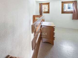 Discover a charming property featuring a cozy bedroom with a wooden dresser and bunk beds.