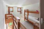 Discover a cozy bedroom featuring a charming bunk bed, perfect for accommodating guests or family.