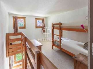 Discover a cozy bedroom featuring a charming bunk bed, perfect for accommodating guests or family.