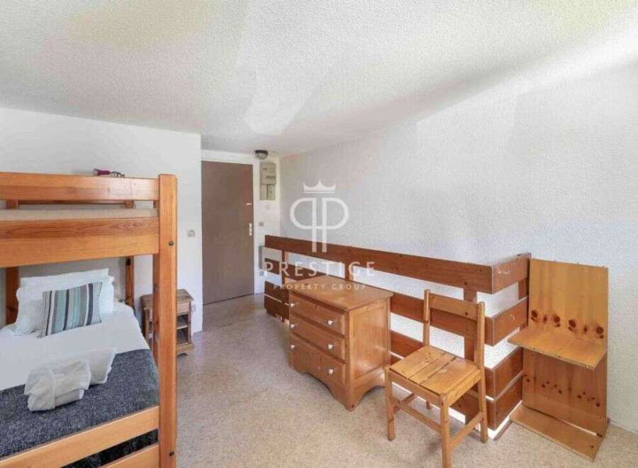 Discover a cozy bedroom featuring a charming bunk bed, perfect for accommodating guests or family.