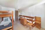 Discover a cozy bedroom featuring a charming bunk bed, perfect for accommodating guests or family.