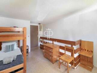 Discover a cozy bedroom featuring a charming bunk bed, perfect for accommodating guests or family.