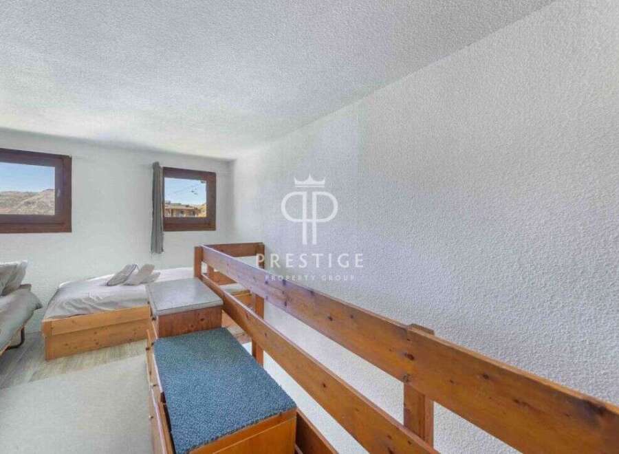 Discover a cozy bedroom with a unique bunk bed design, perfect for maximizing space.