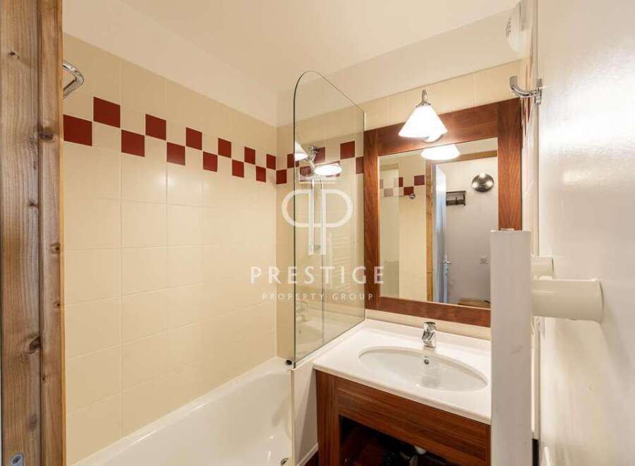 Discover a stylish bathroom featuring a sleek glass shower screen and a modern vanity.