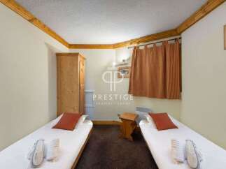 Cozy and inviting bedroom featuring two single beds with fresh linens and plush pillows.