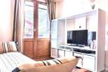 Cozy living space with a comfortable daybed and a modern entertainment unit.
