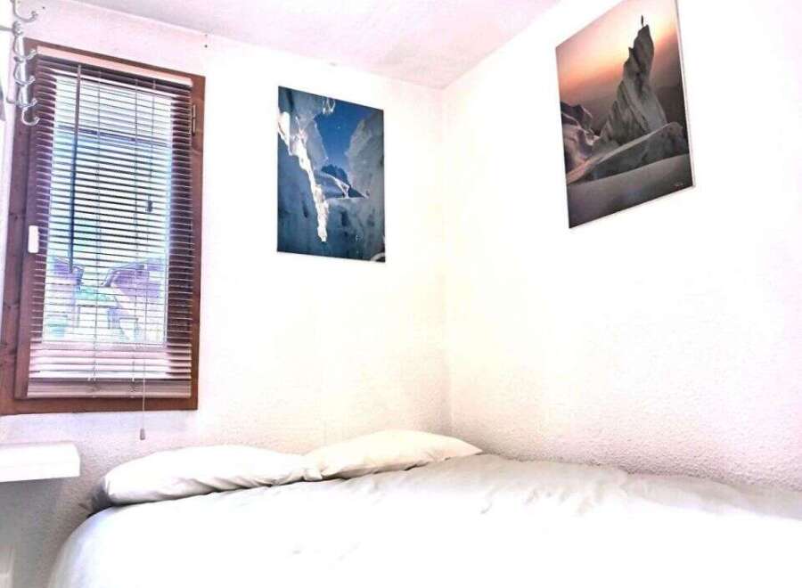 Cozy bedroom with a comfortable bed and two pillows.