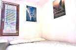 Cozy bedroom with a comfortable bed and two pillows.