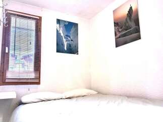 Cozy bedroom with a comfortable bed and two pillows.