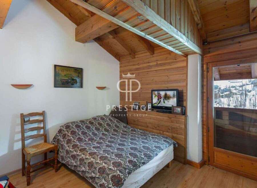 Cozy bedroom with wooden accents and a charming ambiance.