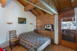Cozy bedroom with wooden accents and a charming ambiance.