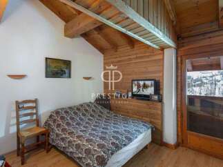 Cozy bedroom with wooden accents and a charming ambiance.