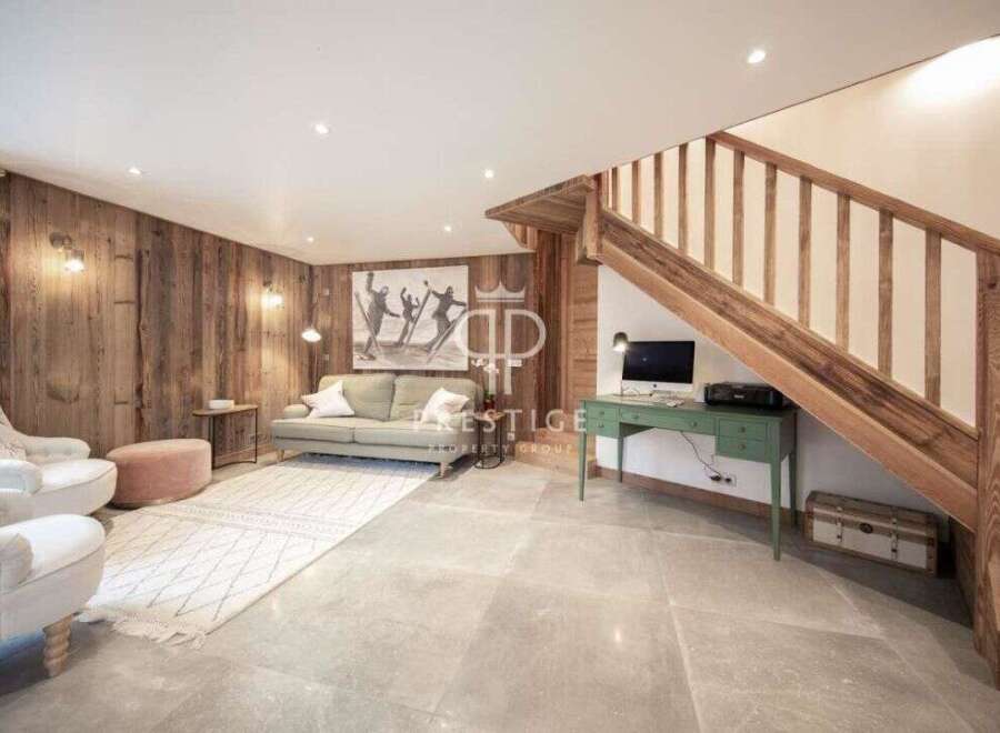 Discover the charm of this stunning property, featuring a cozy living area with wooden paneling and a stylish rug.