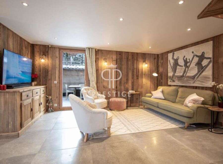 Experience luxury living in this stunning property, featuring a cozy living room with a fireplace and a modern kitchen.