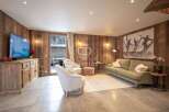 Experience luxury living in this stunning property, featuring a cozy living room with a fireplace and a modern kitchen.