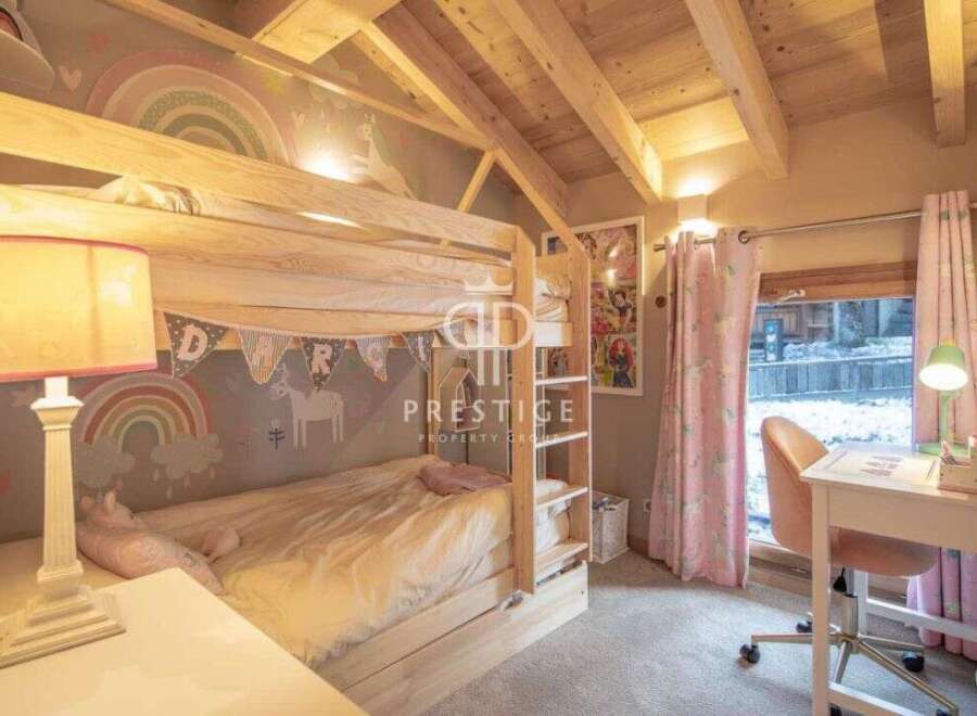 Charming children's bedroom featuring a cozy bunk bed with whimsical decor.
