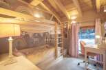 Charming children's bedroom featuring a cozy bunk bed with whimsical decor.