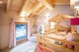Discover a charming children's bedroom with a cozy wooden bed frame.