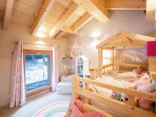 Discover a charming children's bedroom with a cozy wooden bed frame.