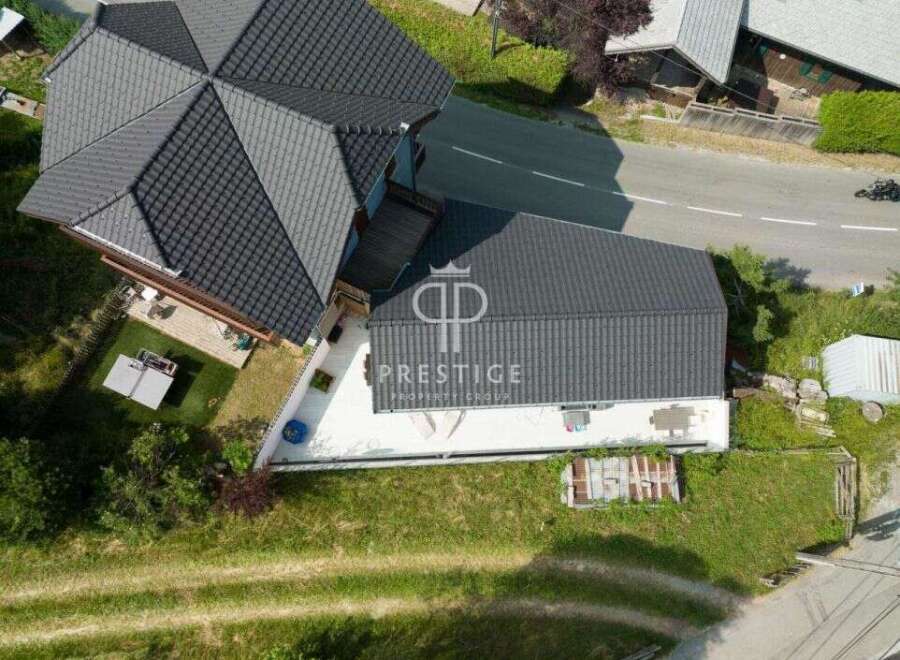 Discover this stunning property featuring a modern design and a sleek, dark roof.