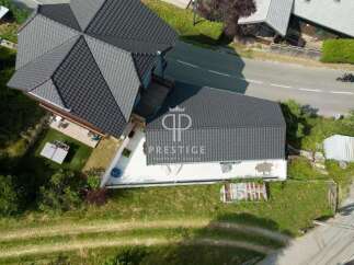 Discover this stunning property featuring a modern design and a sleek, dark roof.