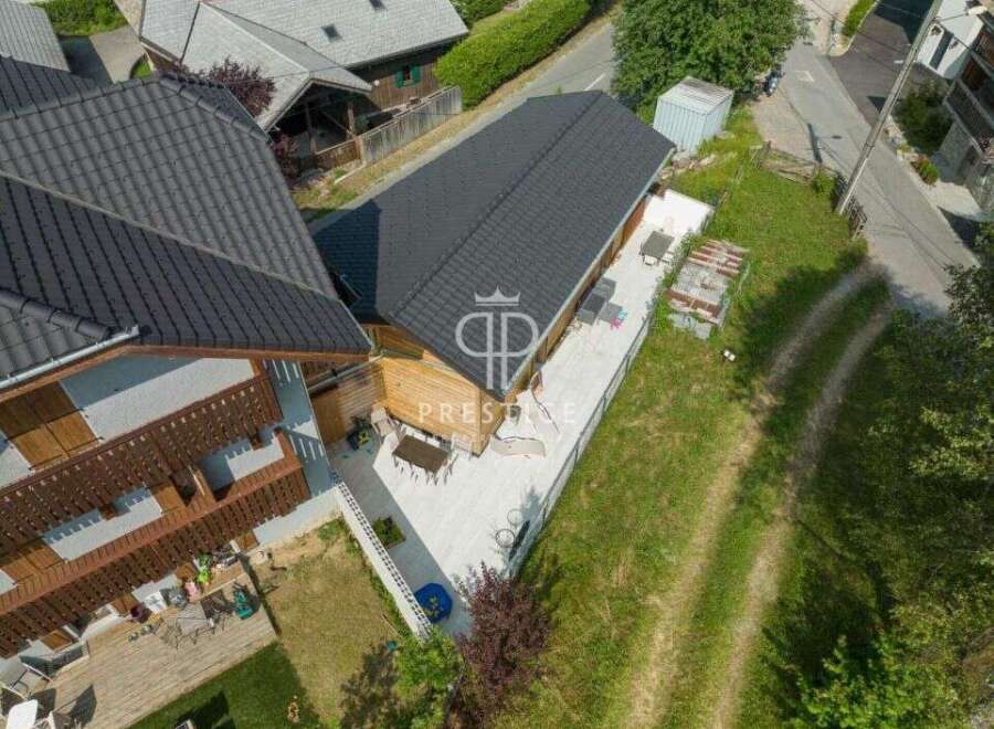 Discover a stunning property with a modern design and a beautiful wooden facade.