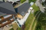 Discover a stunning property with a modern design and a beautiful wooden facade.