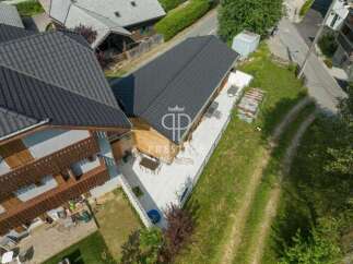 Discover a stunning property with a modern design and a beautiful wooden facade.