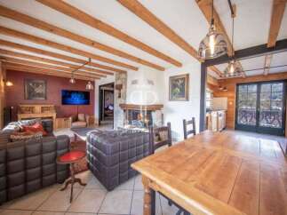 Experience rustic elegance in this stunning property, featuring exposed wooden beams and a cozy fireplace.