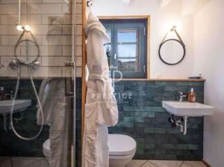 This stunning bathroom features a modern design with a touch of rustic charm.