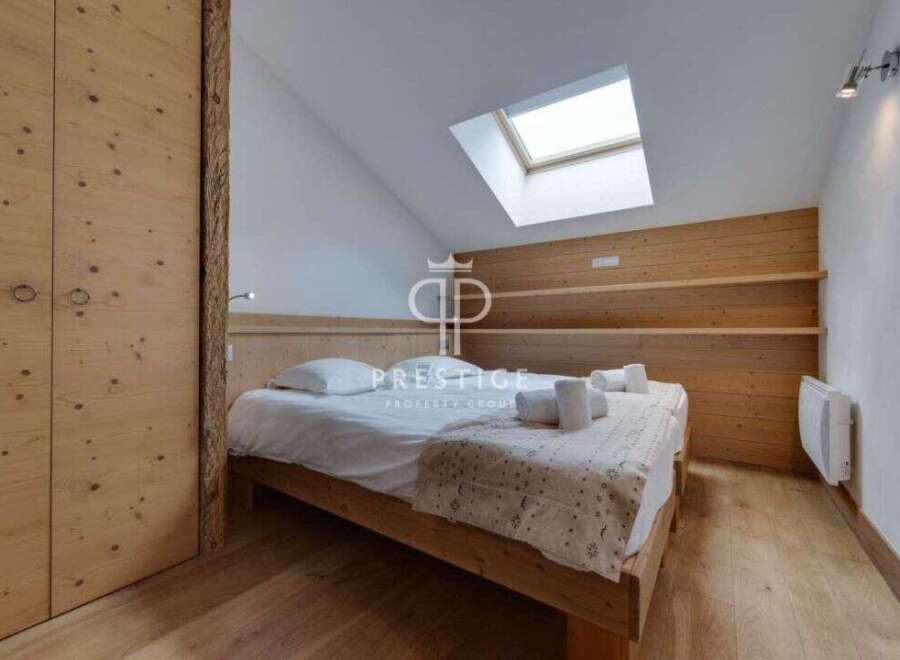 Discover the charm of this cozy bedroom, featuring a unique wooden design that exudes warmth and character.