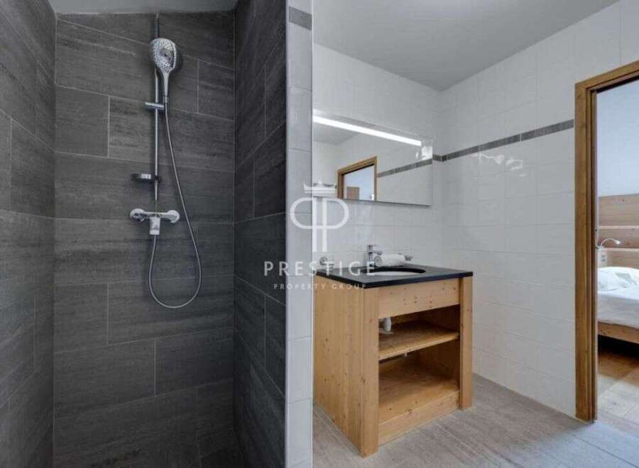 Discover a modern bathroom with a sleek shower and stylish vanity.