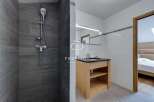 Discover a modern bathroom with a sleek shower and stylish vanity.