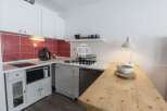 Discover this charming studio apartment featuring a well-equipped kitchenette, perfect for preparing meals.