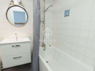 Discover a charming bathroom with a modern vanity and a relaxing bathtub.