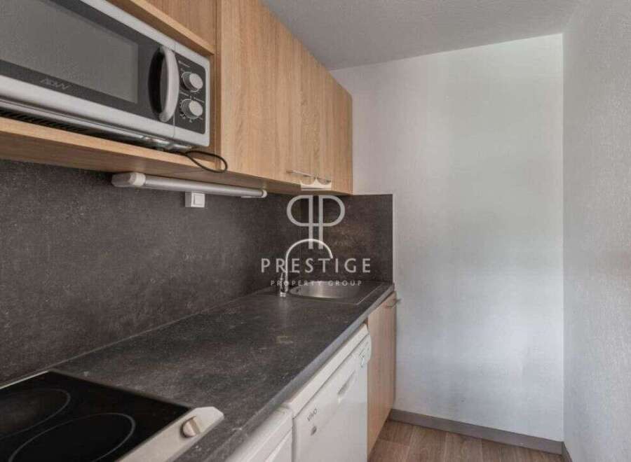 Discover a modern kitchen with sleek countertops and a built-in microwave, perfect for effortless meal preparation.