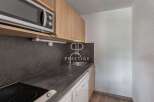 Discover a modern kitchen with sleek countertops and a built-in microwave, perfect for effortless meal preparation.