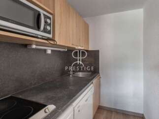 Discover a modern kitchen with sleek countertops and a built-in microwave, perfect for effortless meal preparation.