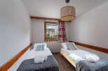 Cozy bedroom with two single beds, perfect for a comfortable stay.